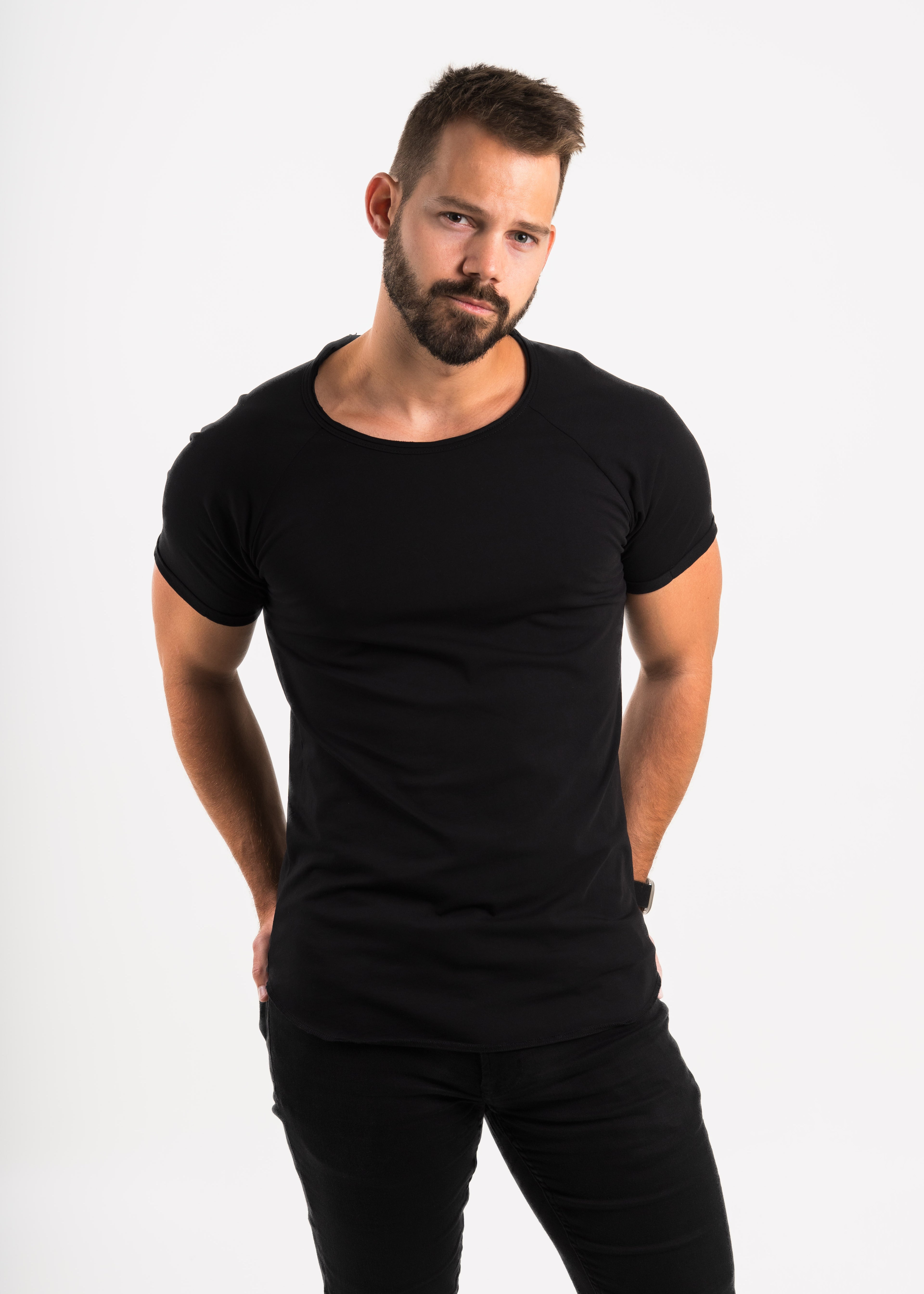 Man wearing a tailored Norloom black t-shirt and pants on a white background