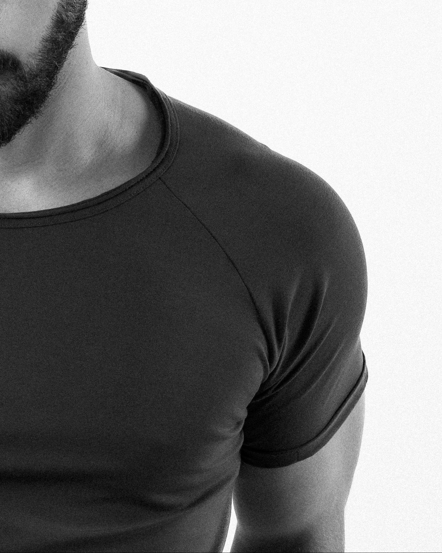 Man wearing a black t-shirt against a white background